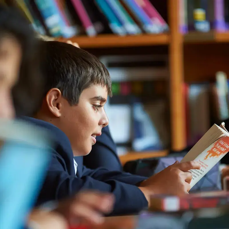 Radnor pupil reading a book in the library