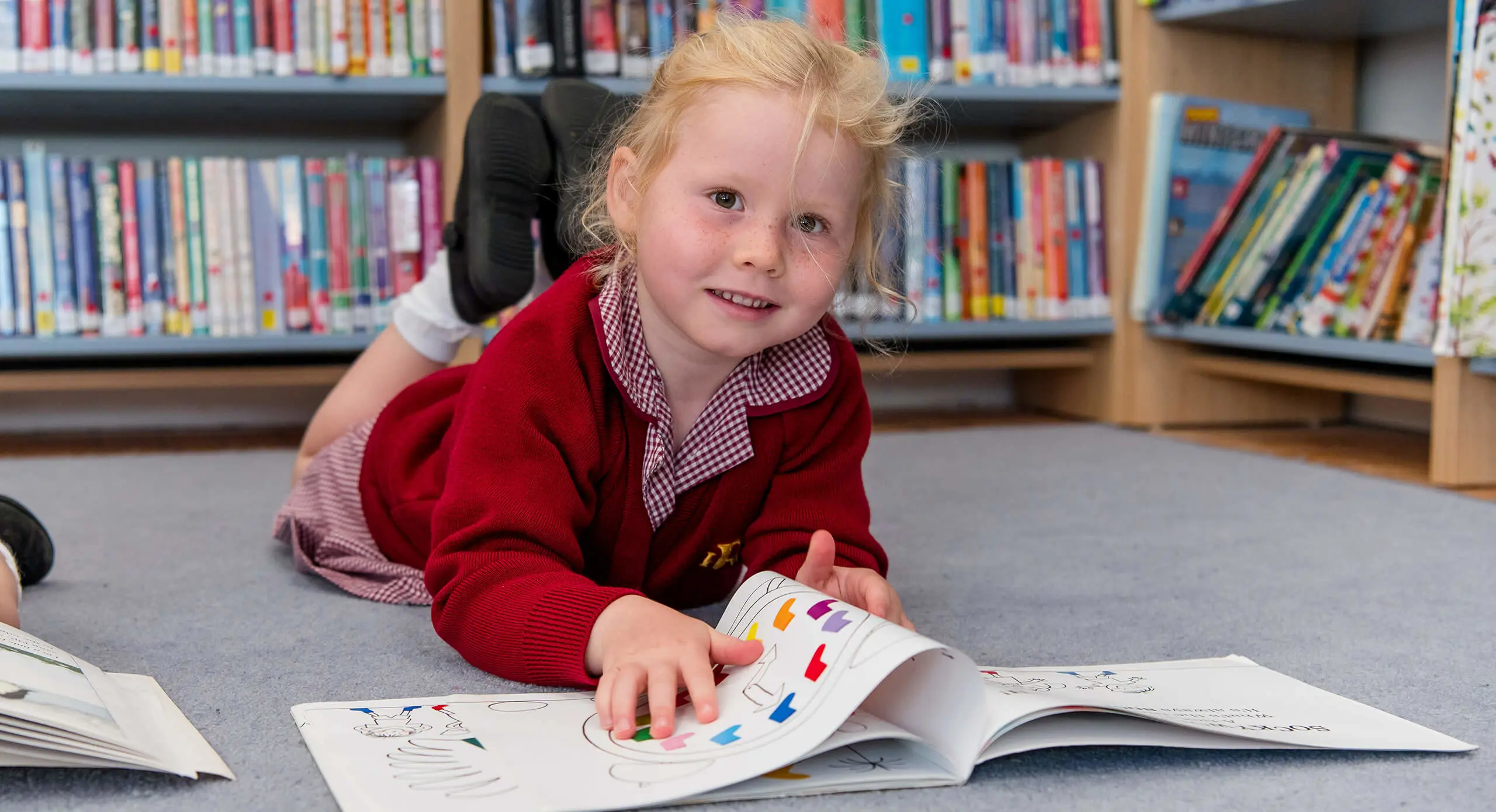 Pre-Prep Radnor House Sevenoaks pupil reading in the library