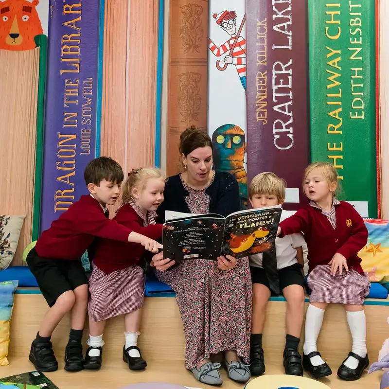 Radnor House Sevenoaks pre-prep pupils reading with a teacher in the library