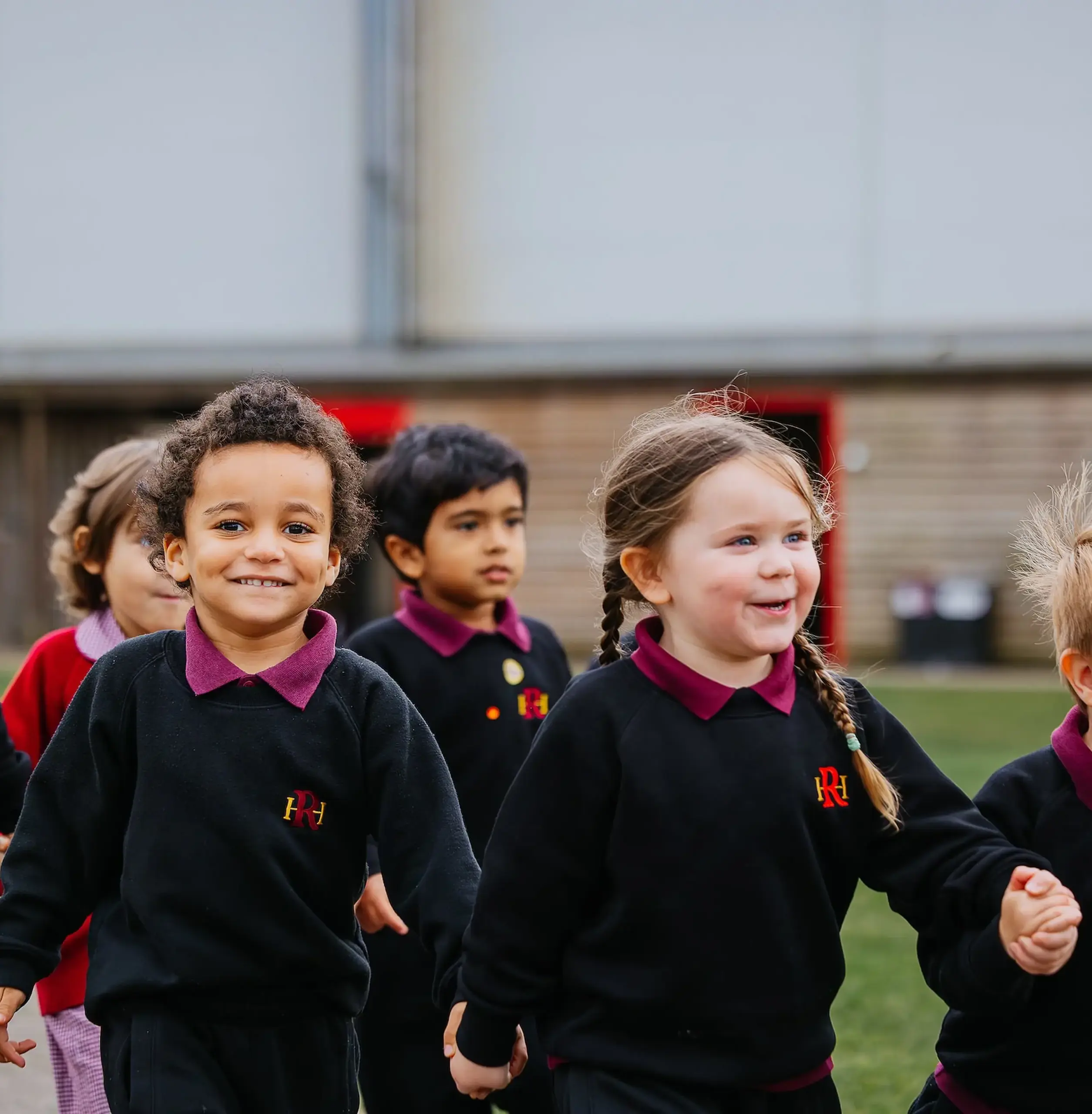 Children walking, holding hands in twos