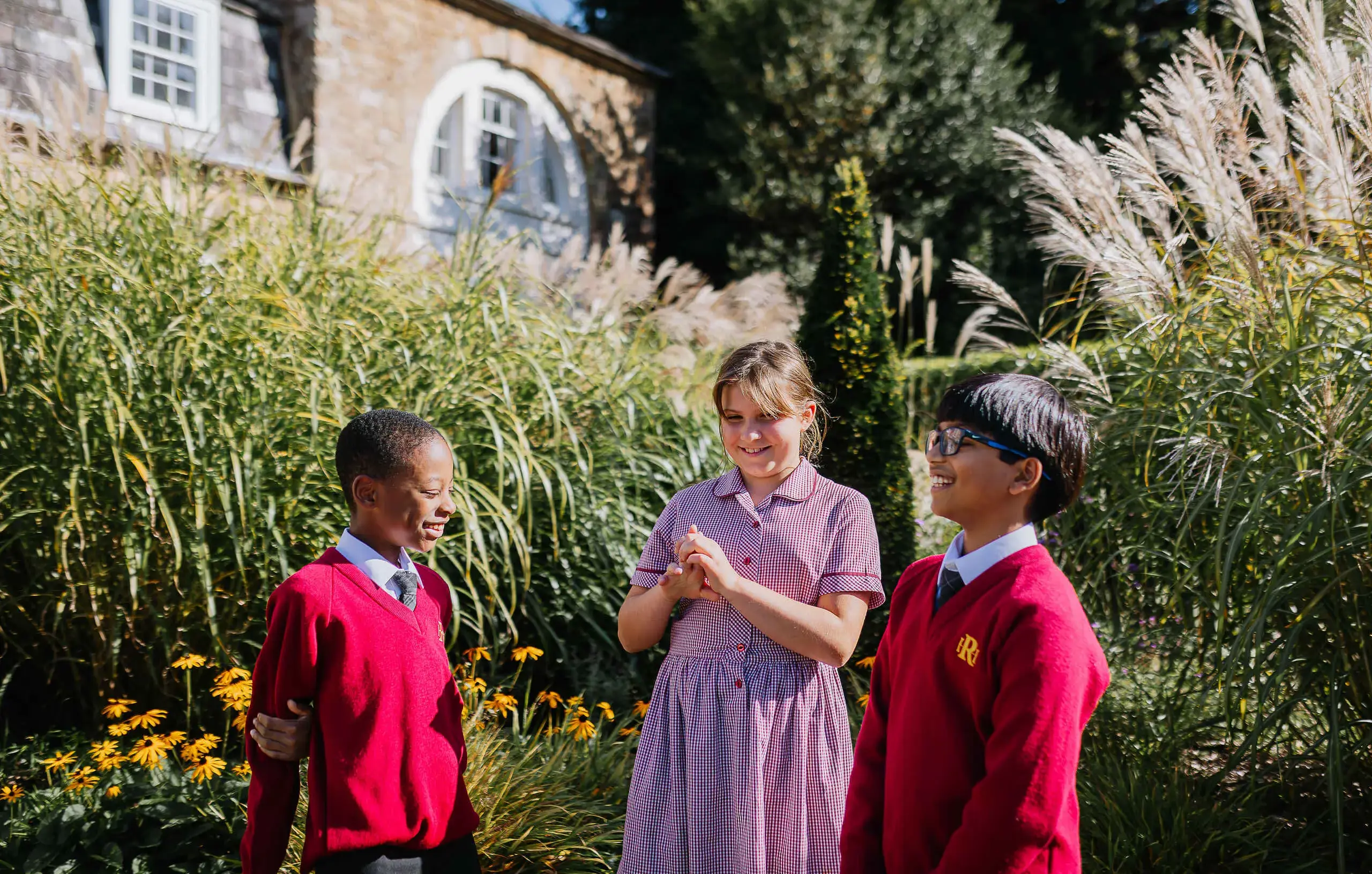 Three students chatting outside