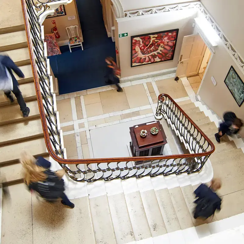 Pupils on staircase at Radnor House School Sevenoaks