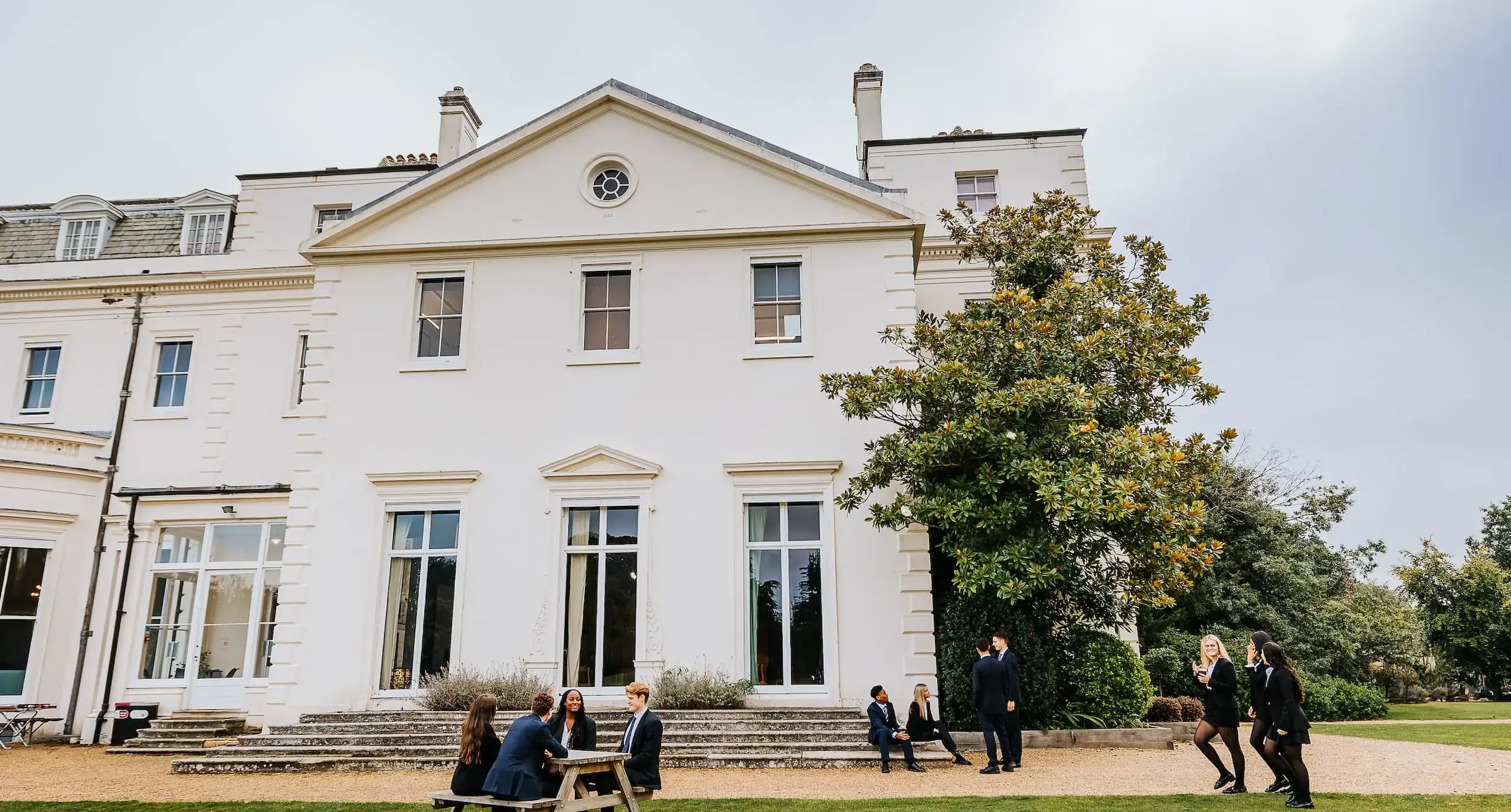 Students wandering outside white Radnor House building