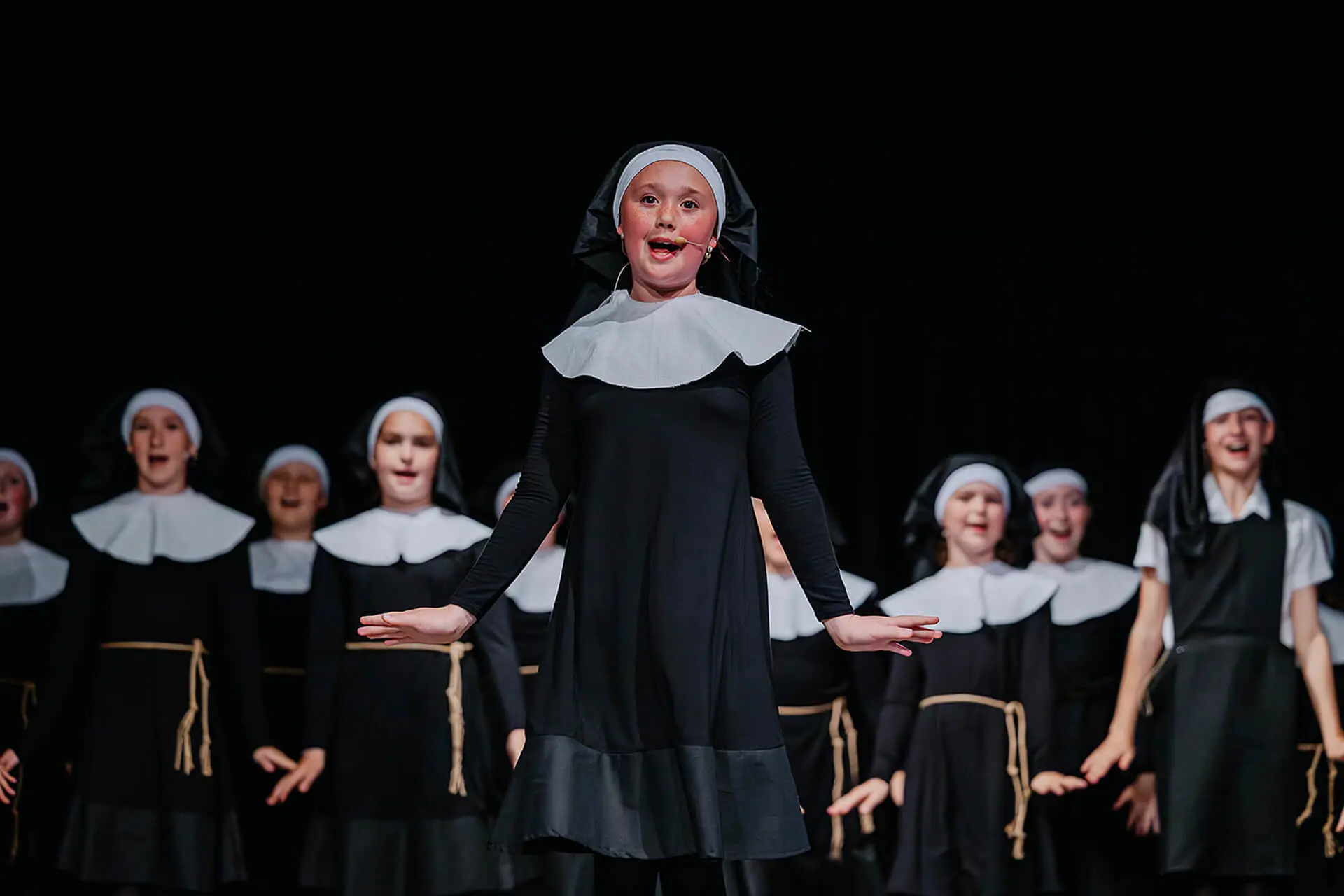 Pupil performing on stage at Radnor House Sevenoaks